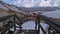 Wooden footpath with railing leading through geothermal area SeltÃºn with steaming hot springs, fumaroles.