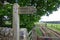 Wooden footpath sign to Hadrian`s Wall