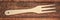 Wooden fork against weathered wood