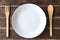 wooden fork and spoon and empty plate