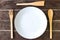 wooden fork and spoon and empty plate