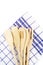 Wooden forks, spoons and spatulas on kitchen towel on w