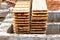 Wooden formwork boards stacked at the construction site. Storage of building materials at the construction site. Formwork for