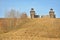 Wooden fortress in the field, old Russian wooden structure, village tower in the field