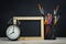 Wooden Frame Blackboard, School Stationary and Alarm Clock. Blank Space