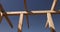 the wooden frame of the building against the blue sky