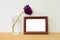 Wooden frame with empty center for copy space and vase with purple tulip