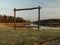 Wooden frame on the lake shore, sunrise light