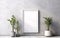 Wooden frame mockup over grey wall with green plants in vase, blank vertical frame with copy space.
