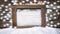 Wooden frame in snow with snowflakes. Christmas background.