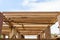 A wooden frame structure with massive supporting pillars prepares the construction of a two-story house