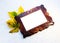 Wooden frame on a white crumpled background with yellow leaves