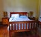 Wooden framed double bed in a quirky rental property in Masterton in New Zealand