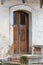 Wooden front door of ancient abandoned building, architectural detail