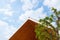 Wooden gabled roof with blue sky