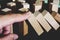 Wooden game strategy, finger stop falling wooden dominoes effect from continuous overthrown or risk, strategy and successful inter