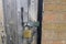 Wooden garage door secured by a brass padlock