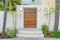 Wooden gate door with modern wall lamps and doorbell at Coronado, San Diego, California