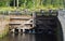 Wooden gates gateway in Malkiya. A fragment of the old part of the Saimaa canal