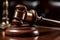 Wooden gavel on court desk on dark background close up. Judges gavel Law and justice concept.