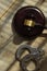 Wooden gavel and handcuff on a wooden surface