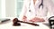 Wooden gavel of judge on table of medical clinic and doctor is filling out paperwork