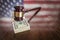 Wooden Gavel Resting on Money with American Flag Reflection