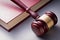 Wooden Gavel Resting on Red Leather Book