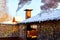 Wooden gazebo with chimney in the yard on a Sunny winter day