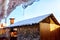 Wooden gazebo with chimney in the yard on a Sunny winter day