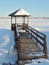 Wooden gazebo by the pond at winter.