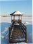 Wooden gazebo by the river at winter.