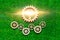 Wooden gears, light bulb on a background of green artificial grass.