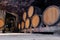 Wooden giant wine oak barrels stacked in rows. Aging, fermentation, store in old wine cellar. Concept sommelier trip