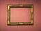 Wooden gilded frame without a photo or picture on a background