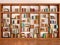 Wooden and glass shelves with different books.