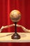 Wooden globe obtained on the lathe, hand-made decorative object on display in a showcase