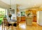 Wooden golden kitchen with dining room and hardwood.