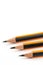 Wooden graphite pencils above white background with copy space