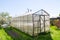 Wooden greenhouse with polycarbonate in the garden