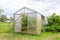 Wooden greenhouse with polycarbonate in the garden