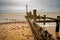 Wooden groyne and sea defences on a sandy beach on the Norfolk coast