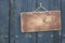 Wooden grunge signboard on planks wall background