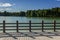 Wooden guardrail at the lakeside in a park