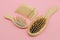 Wooden hairbrushes on a pink background