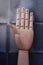 Wooden hand with five fingers raised and numbered with numbers one, two, three, four and five