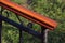 Wooden hand-rail close-up on defocused grass background diagonal