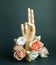 Wooden hand show blessing gesture with flowers on dark green background