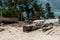 Wooden handmade boat with mast on fishing village shore in Zanzibar