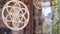 Wooden handmade circles are rotating hanging on a rope right in the shop window. Ð¡reative exterior of the store outside